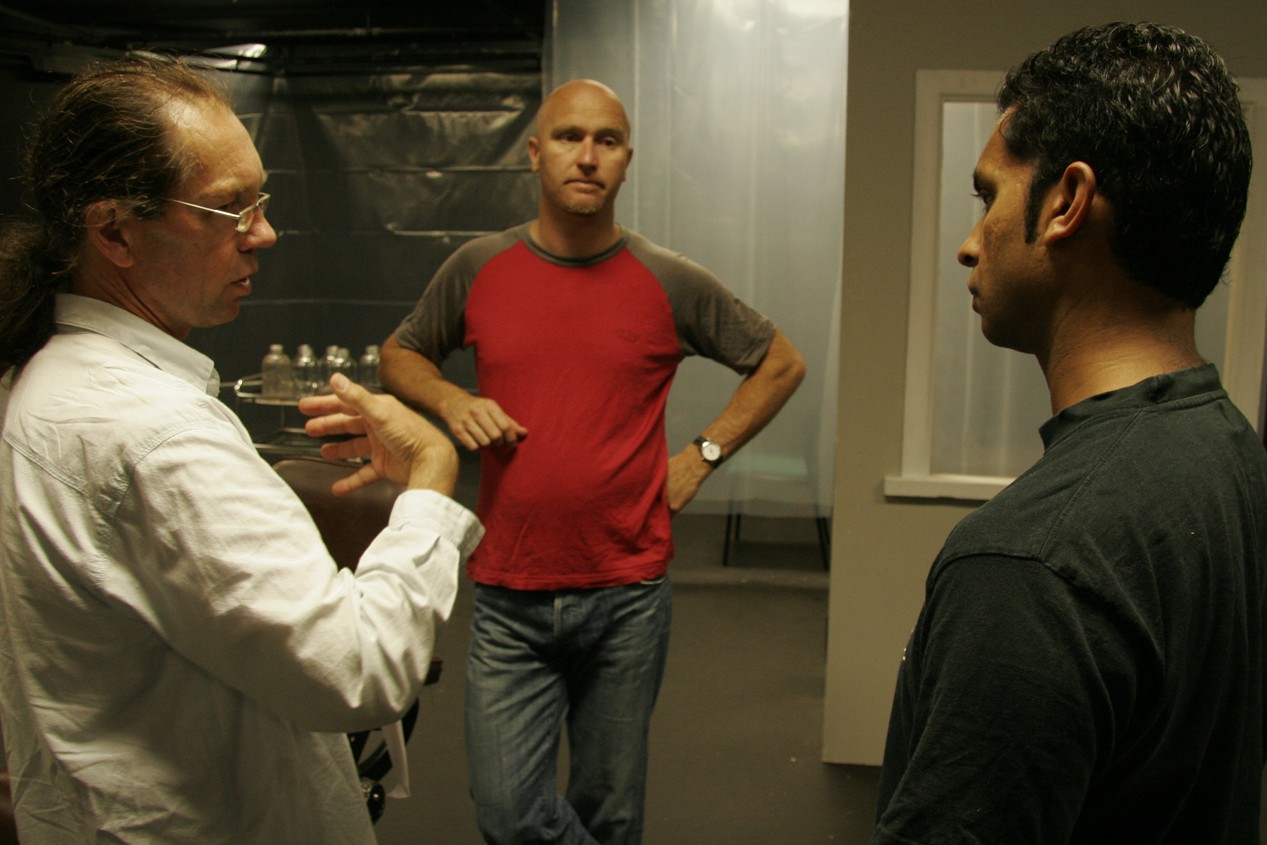 Murray Edmond, Justin Lewis and Jacob Rajan stand in a circle discussing something