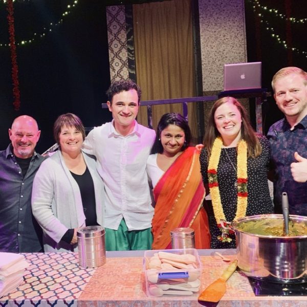 Andrew Potvin and family stand with the Mrs Krishnan's Party cast in front of the cooking area