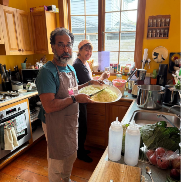 Jake chops onions, while Jude supervises the washing up.