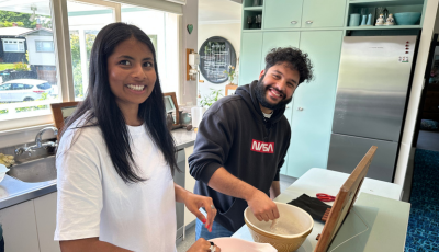 Alisha & Jehangir look at the camera while fitting fake teeth