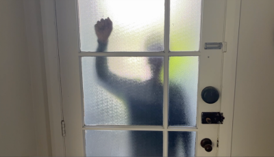 Jake stands behind a door and knocks